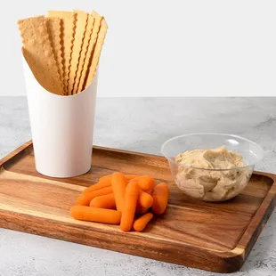 carrots and crackers on a cutting board