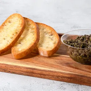 slices of bread and a bowl of pesto