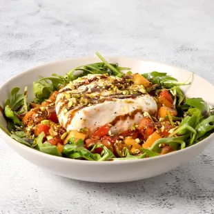 a bowl of salad with chicken and vegetables