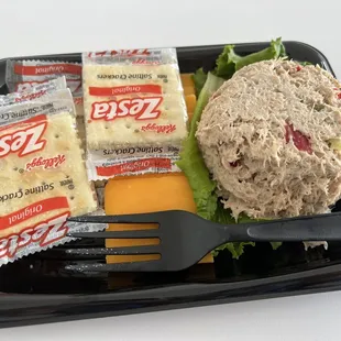 a sandwich with cheese, lettuce, and crackers
