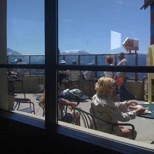 a woman sitting at a table outside