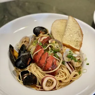 a plate of pasta with clams and clams