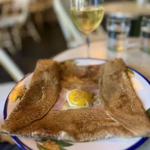 a plate of food and a glass of wine