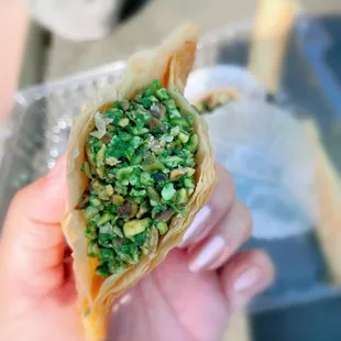 a hand holding a pastry