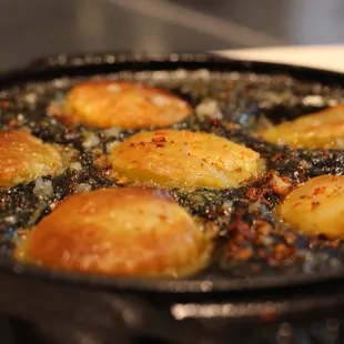 a frying pan filled with fried potatoes