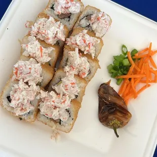 a plate of sushi and vegetables