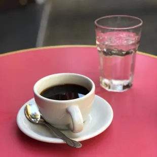 a cup of coffee and a glass of water