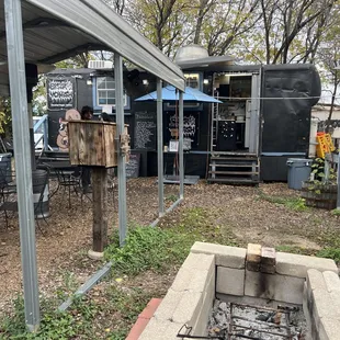 a barbecue area with tables and chairs