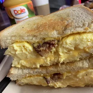 Scrambled eggs, bacon and grilled cheese sandwich
