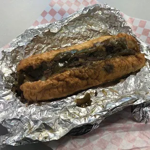 a hot dog wrapped in tin foil