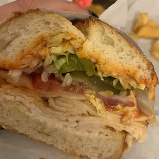 a person holding a sandwich in their hand