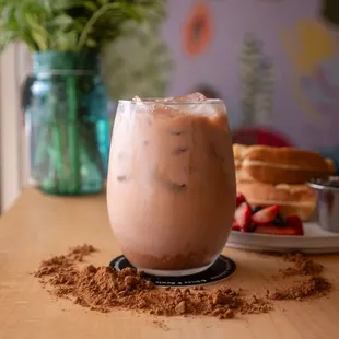 a glass of iced coffee on a table