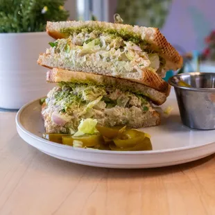 a tuna salad sandwich with pickles