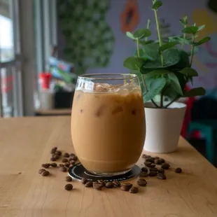 a glass of iced coffee on a table