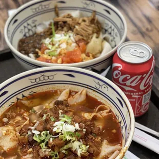 a bowl of soup and a can of coke