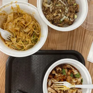 three bowls of food on a tray