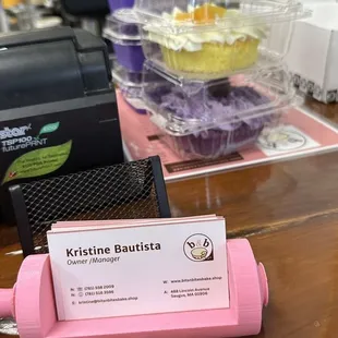 a pink pastry roller with a business card on it