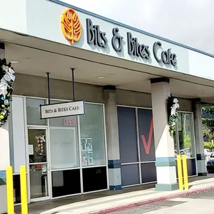 Outside view of Bits &amp; Bited Cafe. By Costco tires, in between Diagnostic Labs and Verizon.