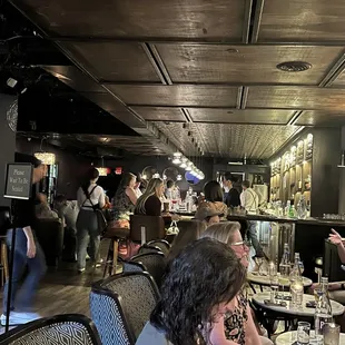 people sitting at tables in a restaurant