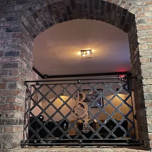 a brick wall with a window and a grill