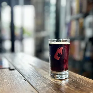 a pint glass on a wooden table