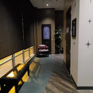 Hallway leading to sister property and bathrooms.