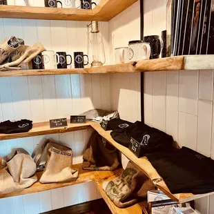 a shelf of coffee mugs and other items