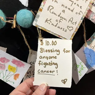 The mom owner  paints these after someone dedicates , pay it  forward wall