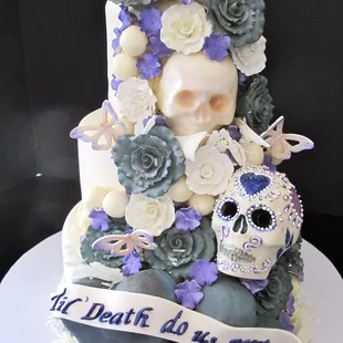 a cake decorated with sugar skulls and flowers