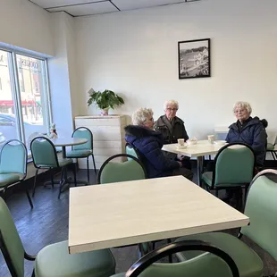 two elderly people sitting at a table