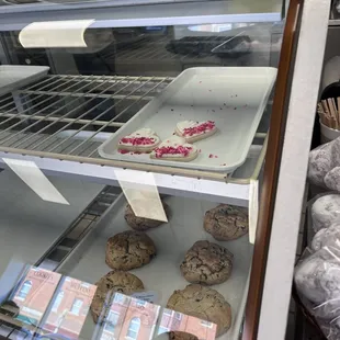a display case filled with cookies and pastries