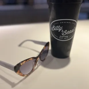 a cup of coffee and sunglasses