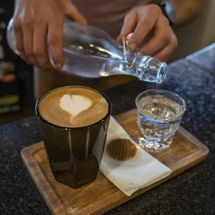 a person pouring milk into a cup