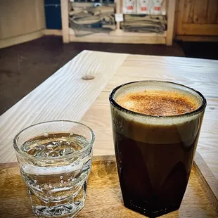 a glass of water and a drink