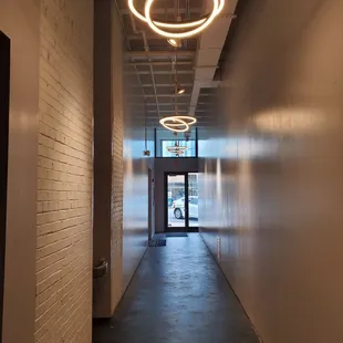 a long hallway with a light fixture hanging from the ceiling