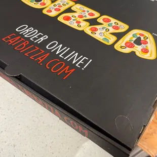 a pizza box on a kitchen counter