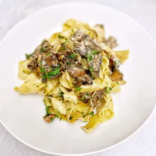 a plate of pasta with mushrooms