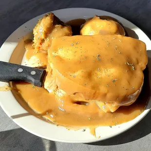 Hot turkey sandwich with dressing and mashed potatoes.