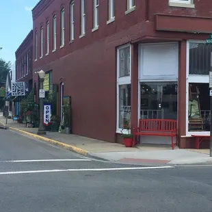 a red bench on the corner