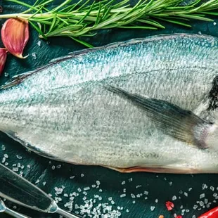 a whole fish on a cutting board