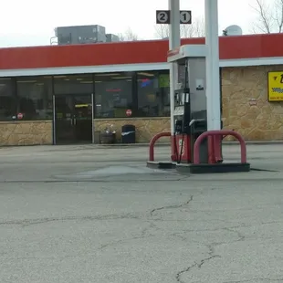 a gas station with a gas pump in the foreground