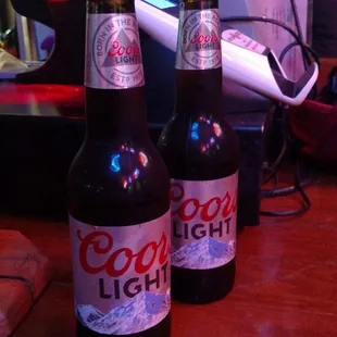 two bottles of beer on a table