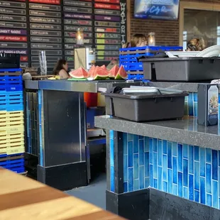 Food prep and dirty dishes on the same area at the bar.