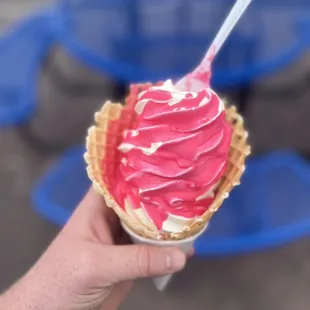Medium vanilla ice cream dipped in cotton candy in a Waffle Cone
