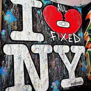 a graffiti covered wall with the words i love new york