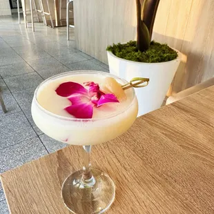 a cocktail with a flower in it