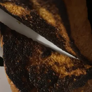Burned French Toast. I&apos;m not sure how chef&apos;s can&apos;t do this. Two different locations, third time trying still burned.