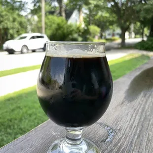 a glass of beer on a wooden table