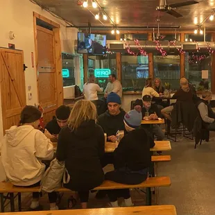 people sitting at tables in a restaurant
