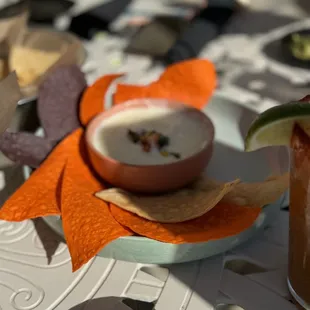 a drink and a bowl of soup on a table